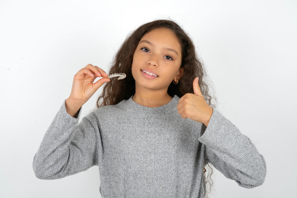 A kid happy with Invisalign in Pearl City.