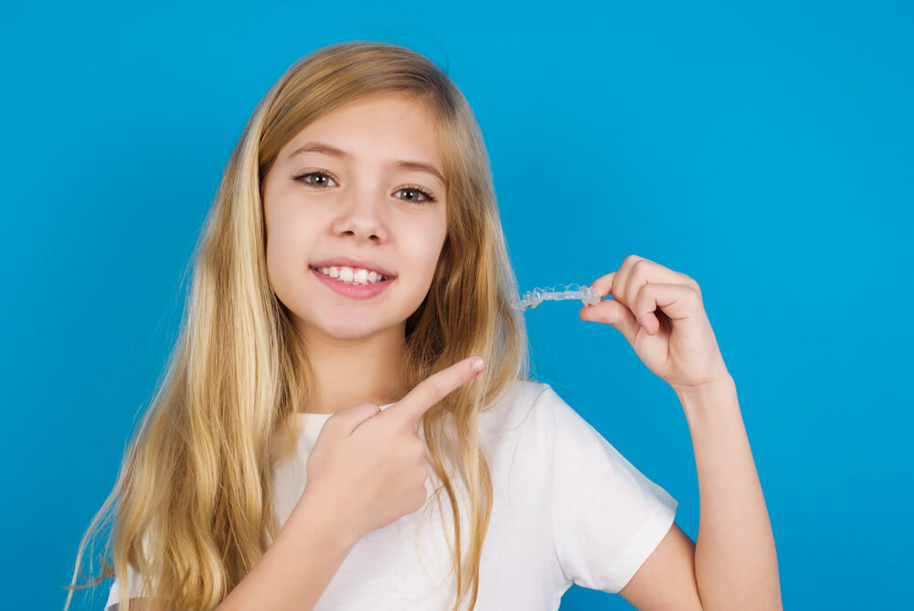 A happy kid with Invisalign in Kapolei