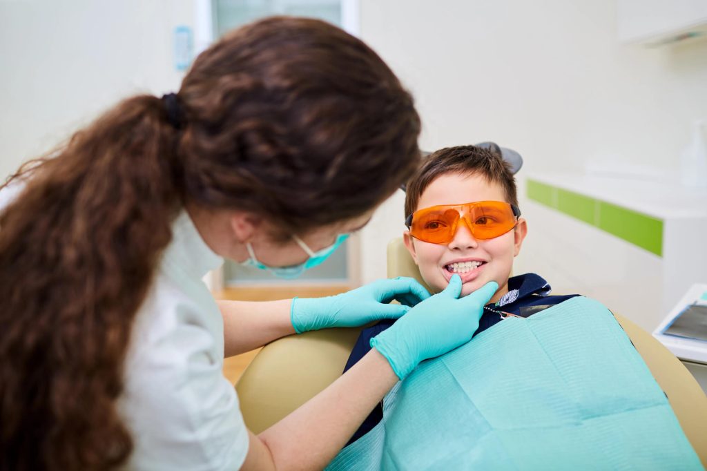 Kailua Pediatric Dentist Giving Dental Sealants to a Kid