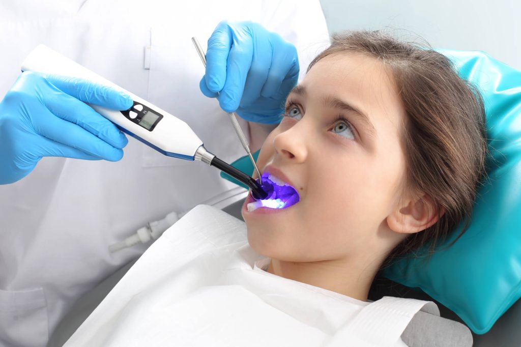 Pediatric Dentist in Honolulu Applying Sealants